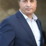 محافظ العقبة أيمن العوايشة يرتدي بدلة رسمية.